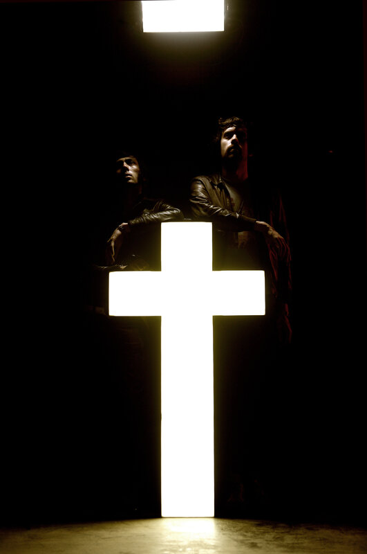 two men with glowing cross