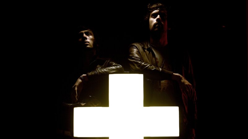 two men with glowing cross