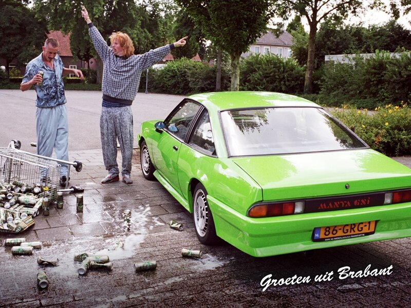 Two men with green car and cans