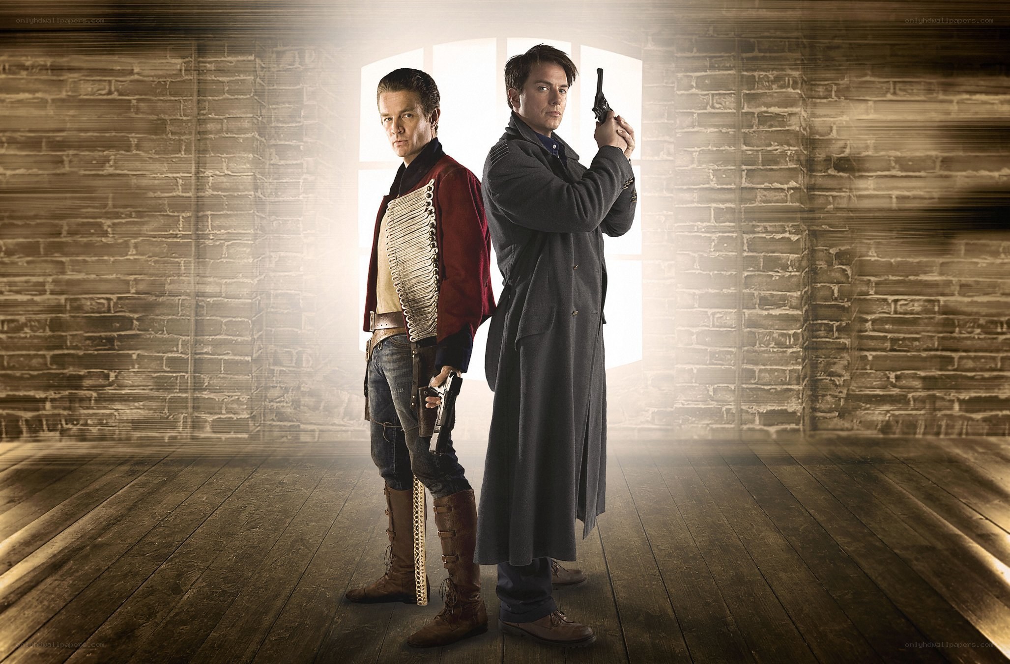 Two men with guns in a warehouse
