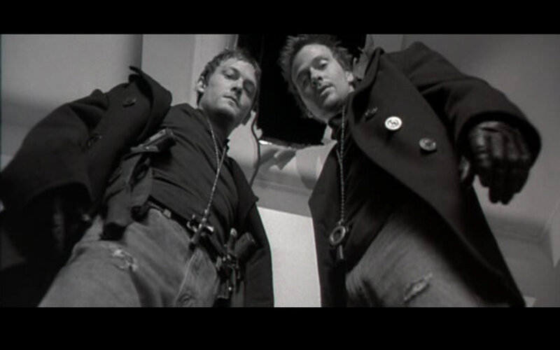 two men with guns in black and white