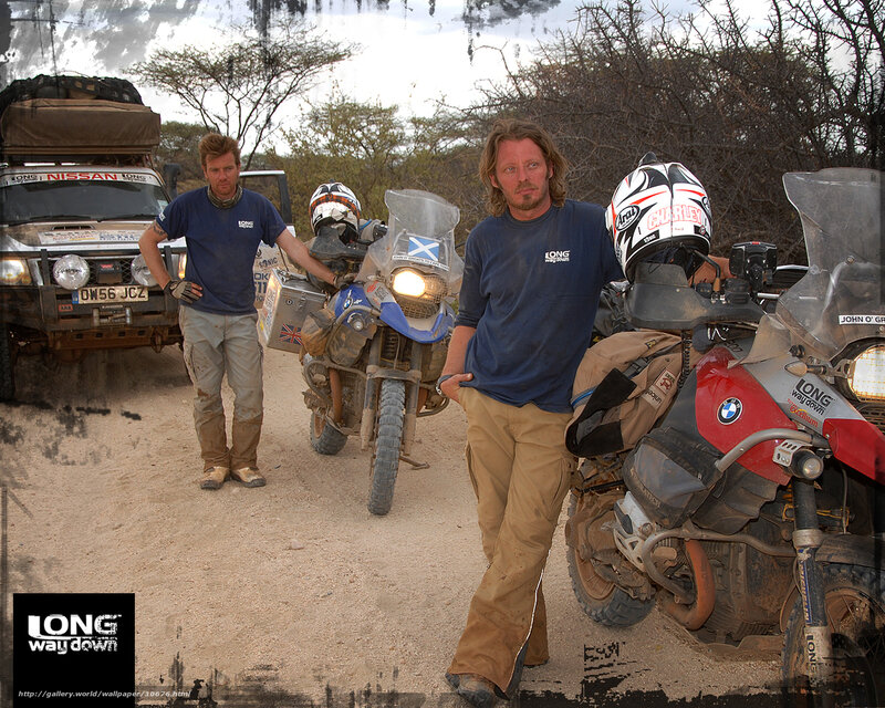 Two men with motorcycles in desert
