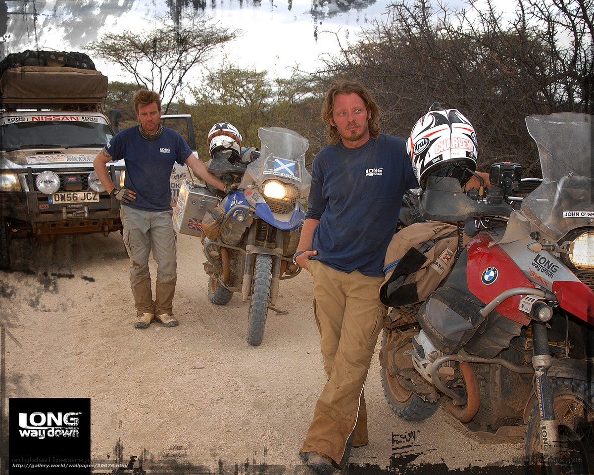 Two men with motorcycles in desert