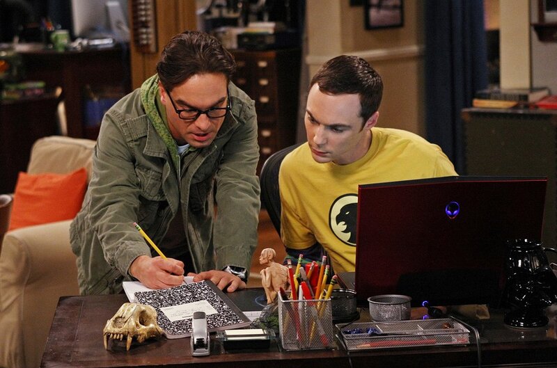 Two men working on a laptop