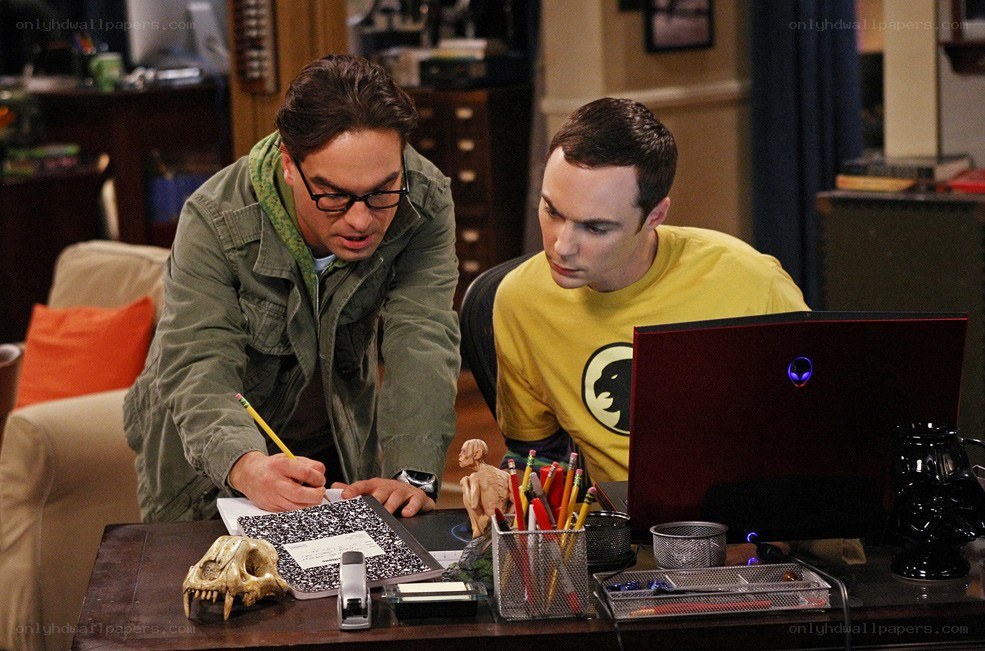Two men working on a laptop