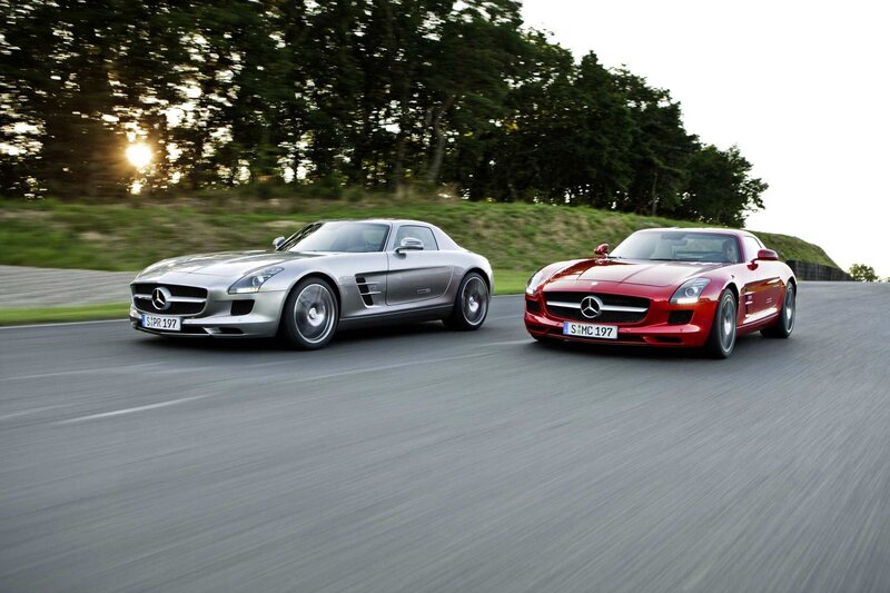 Two Mercedes-Benz SLS AMG cars on a road