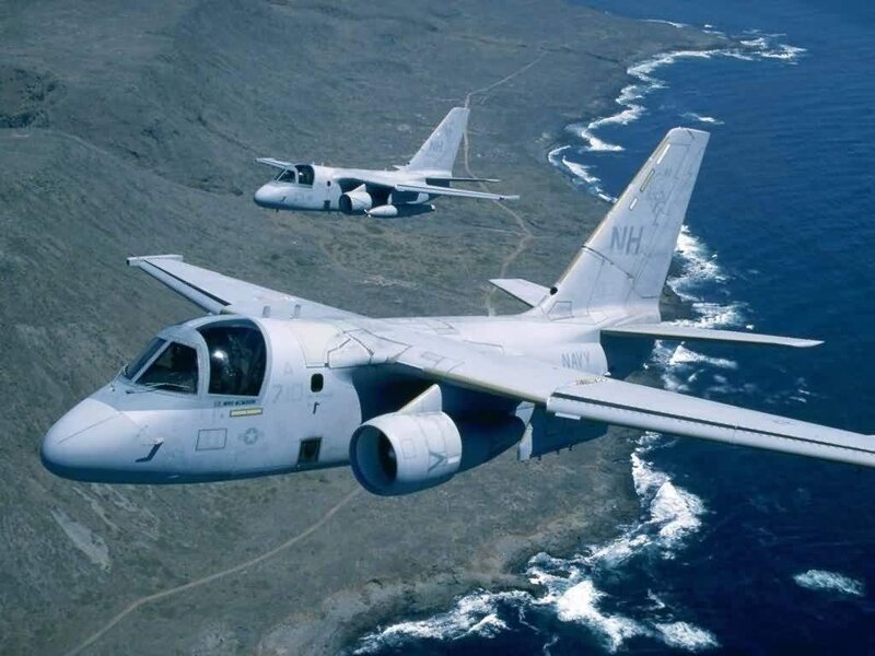 Two military aircraft flying over coast