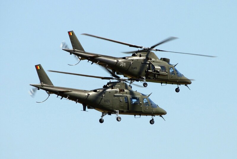 Two military helicopters in flight