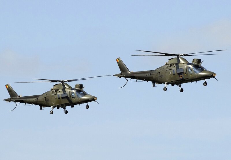 Two military helicopters in flight
