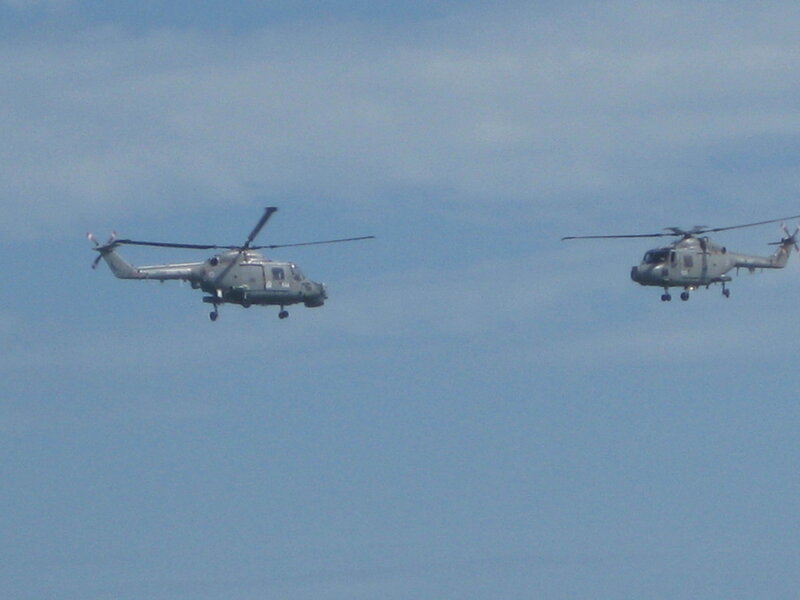 Two military helicopters in flight