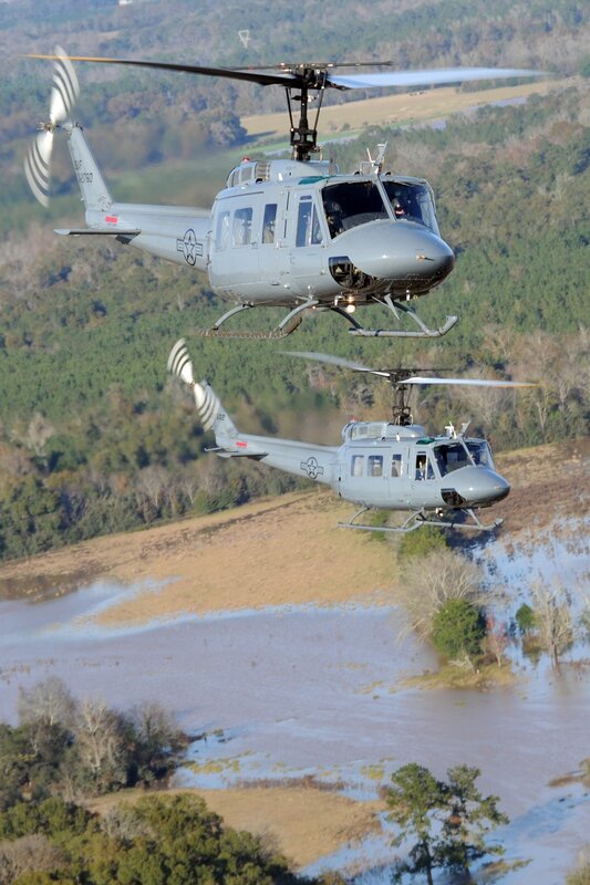 Two military helicopters in flight