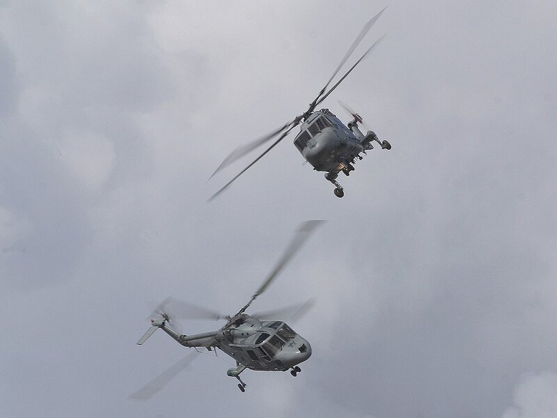 Two military helicopters in flight
