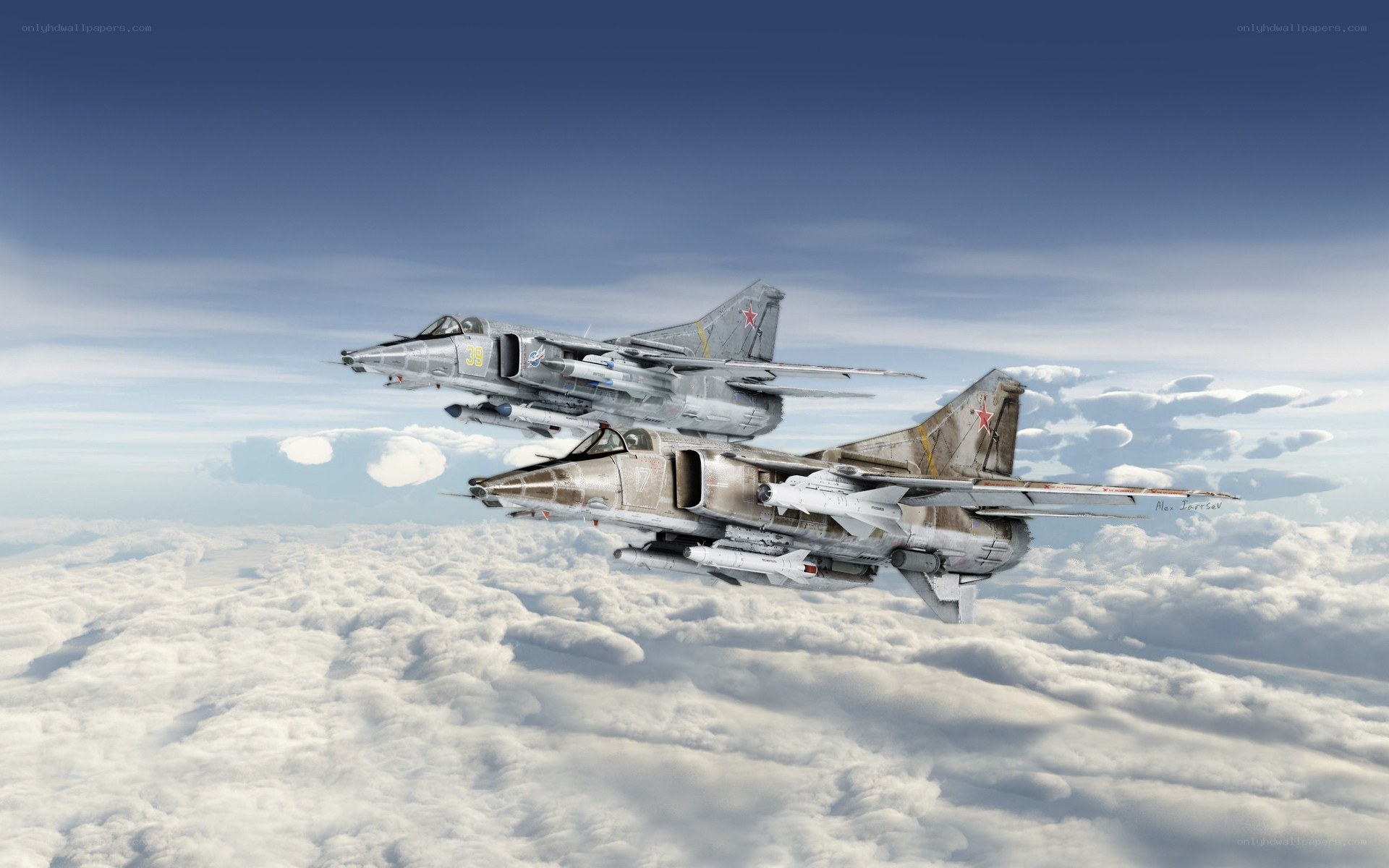 Two military jets flying above clouds