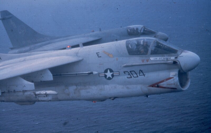 Two military jets flying over ocean