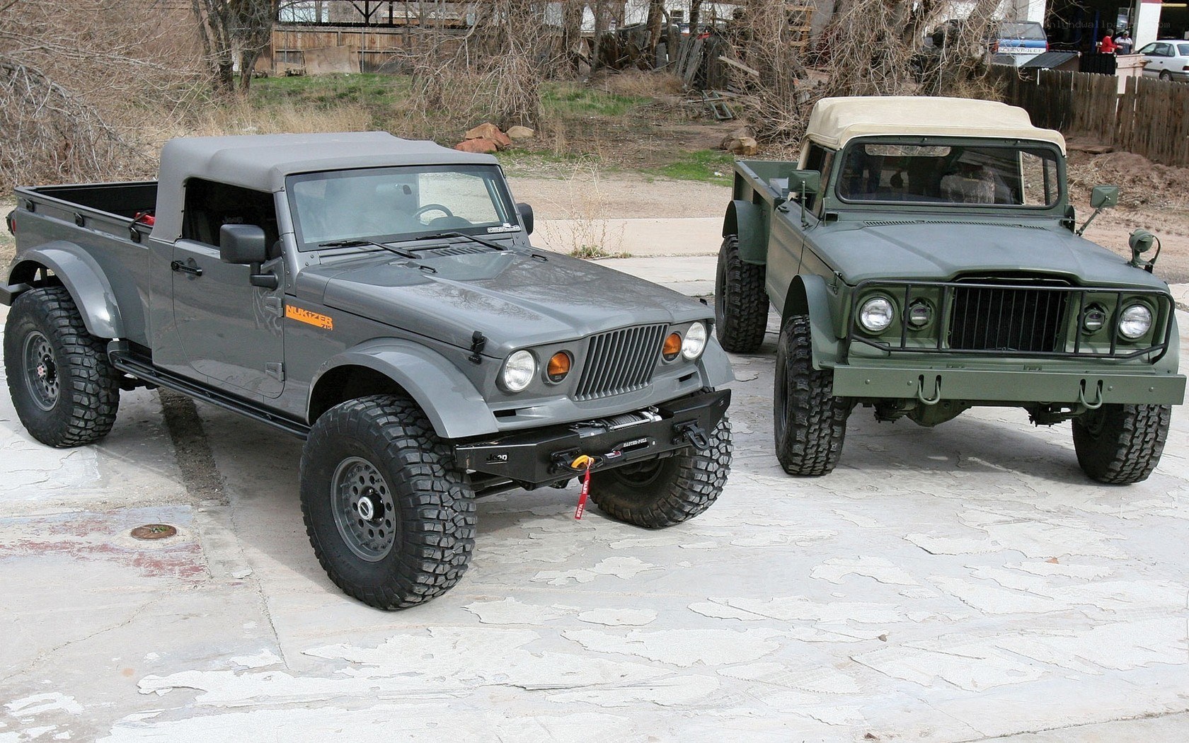 Two military-style trucks parked