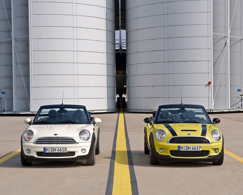 Two MINI Convertibles in front of silos