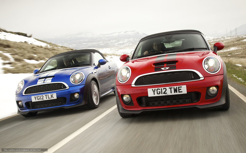 Two MINI Coopers on a road