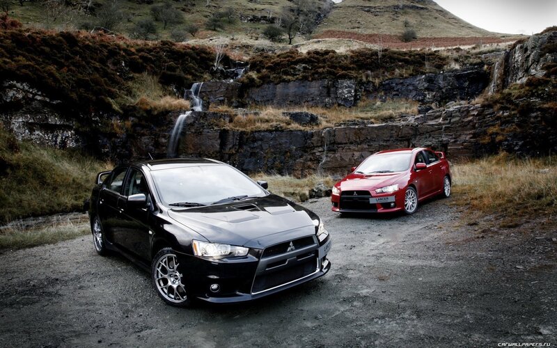 Two Mitsubishi Lancer Cars — Black, Dramatic, Photograph, Waterfall