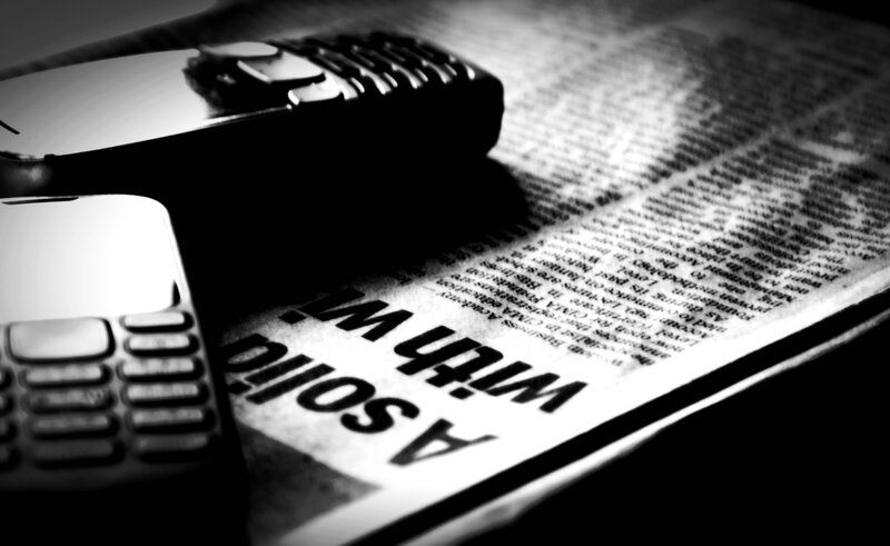 Two Mobile Phones on Newspaper