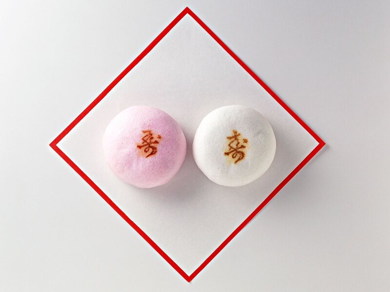 Two mochi sweets on paper