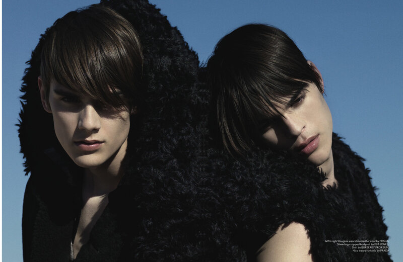 Two models in black fur coats