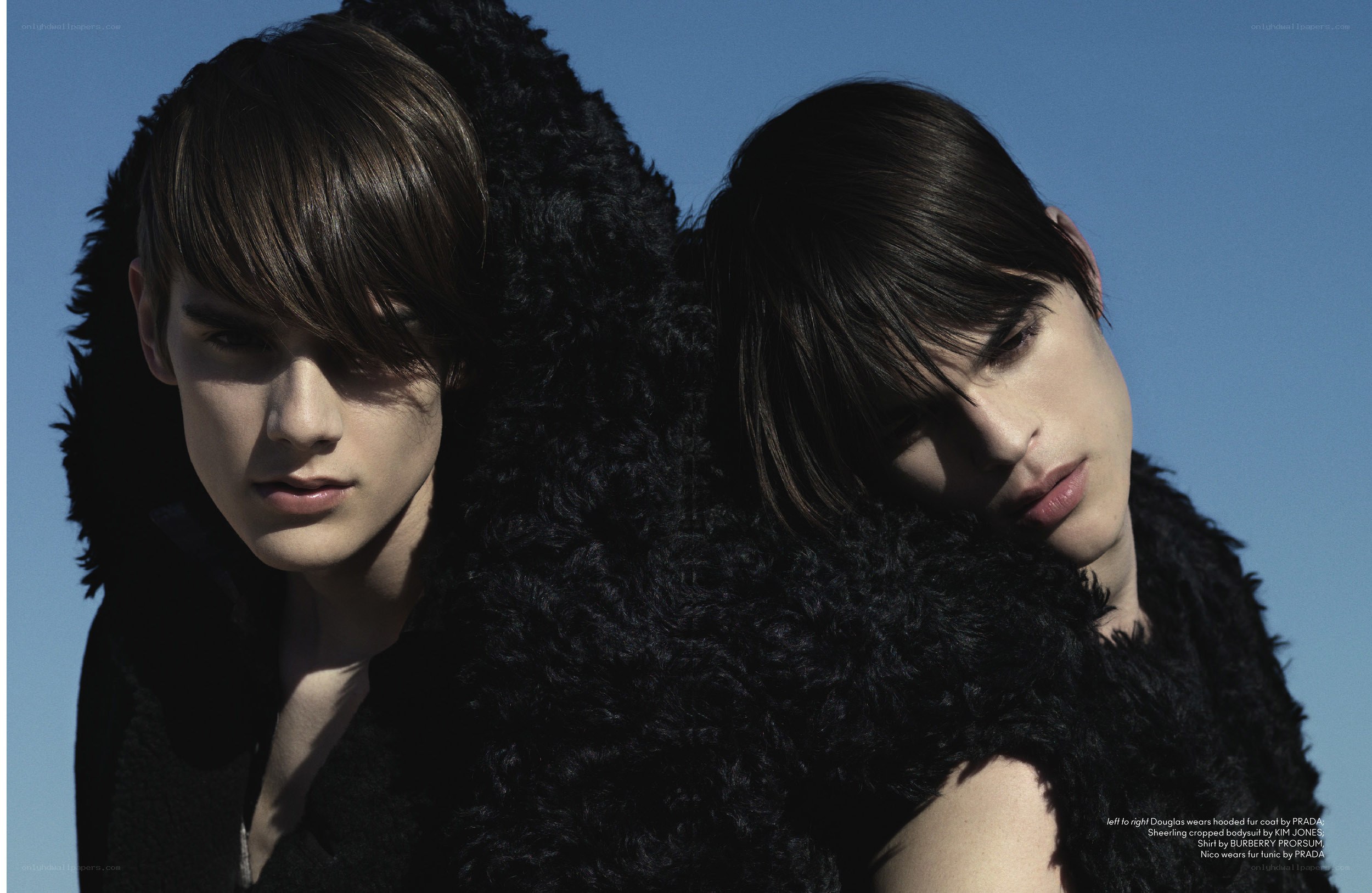 Two models in black fur coats