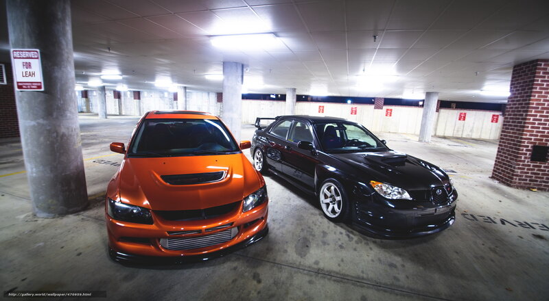 Two modified cars in a garage
