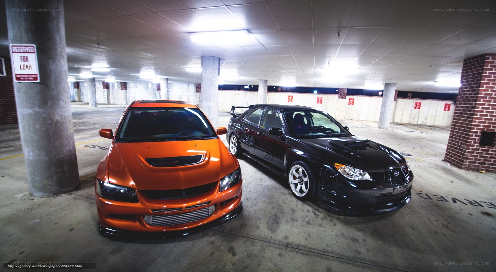 Two modified cars in a garage