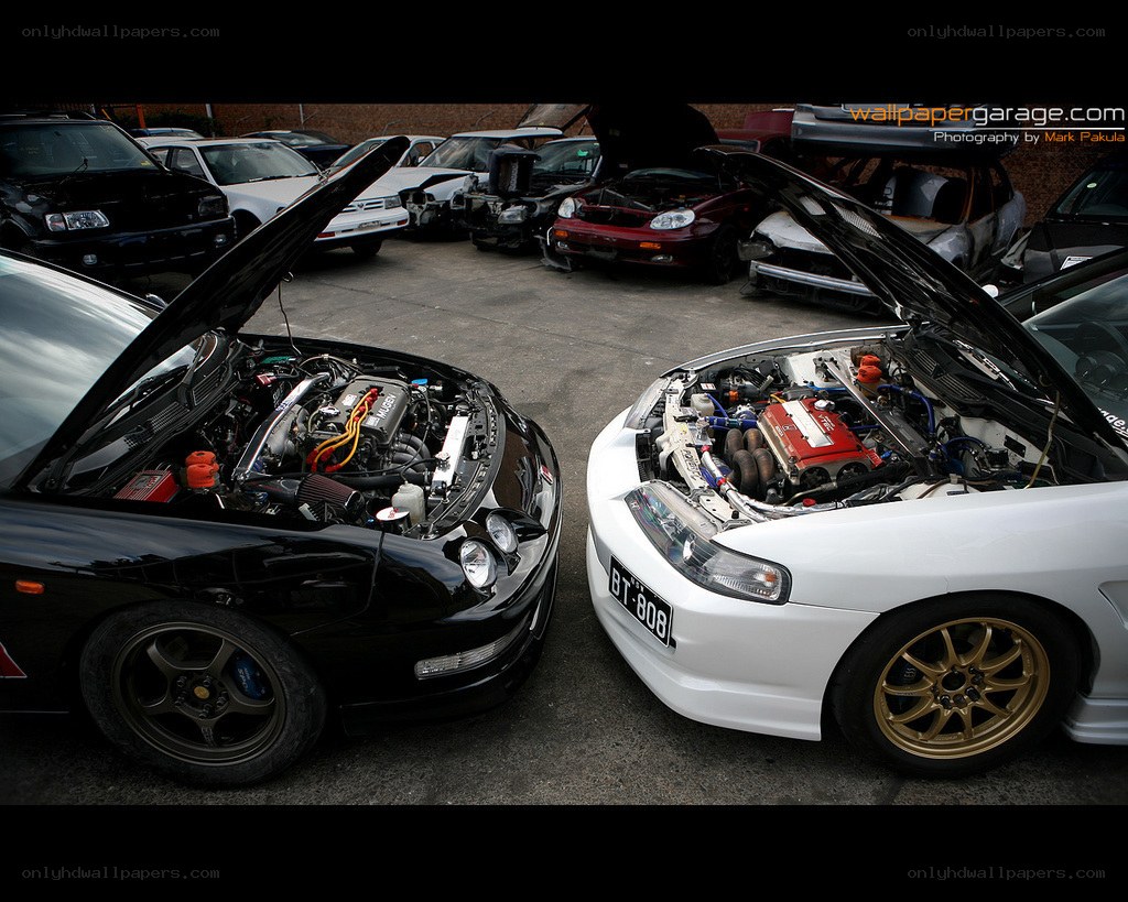 Two modified cars with open hoods
