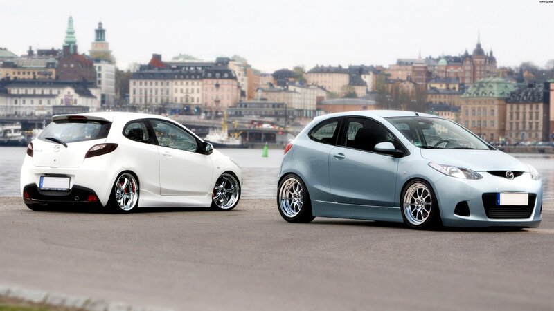 Two modified Mazda hatchbacks
