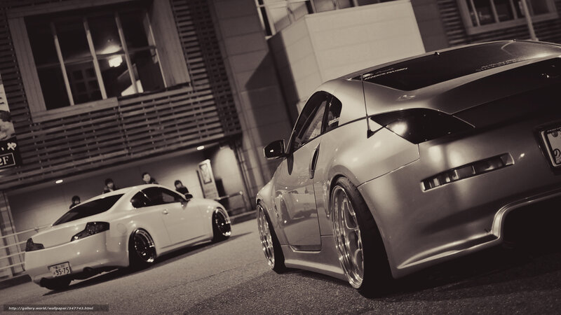 Two modified sports cars at night