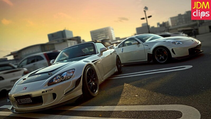 Two modified sports cars at sunset