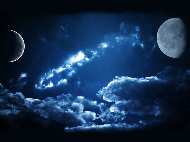 Two moons in a cloudy night sky