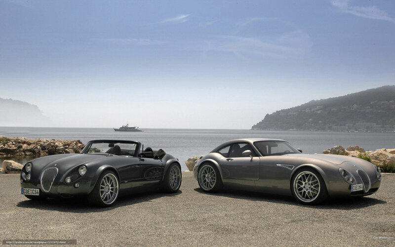 Two Morgan cars by the sea