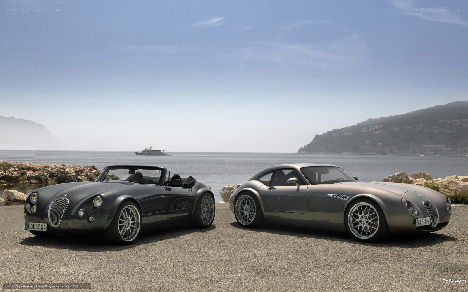 Two Morgan cars by the sea