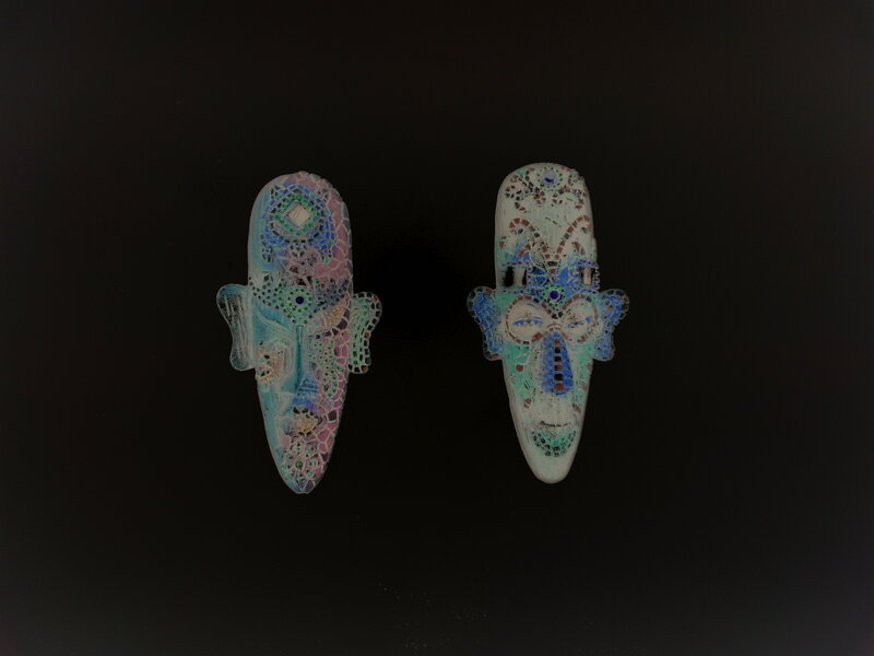 Two mosaic face sculptures