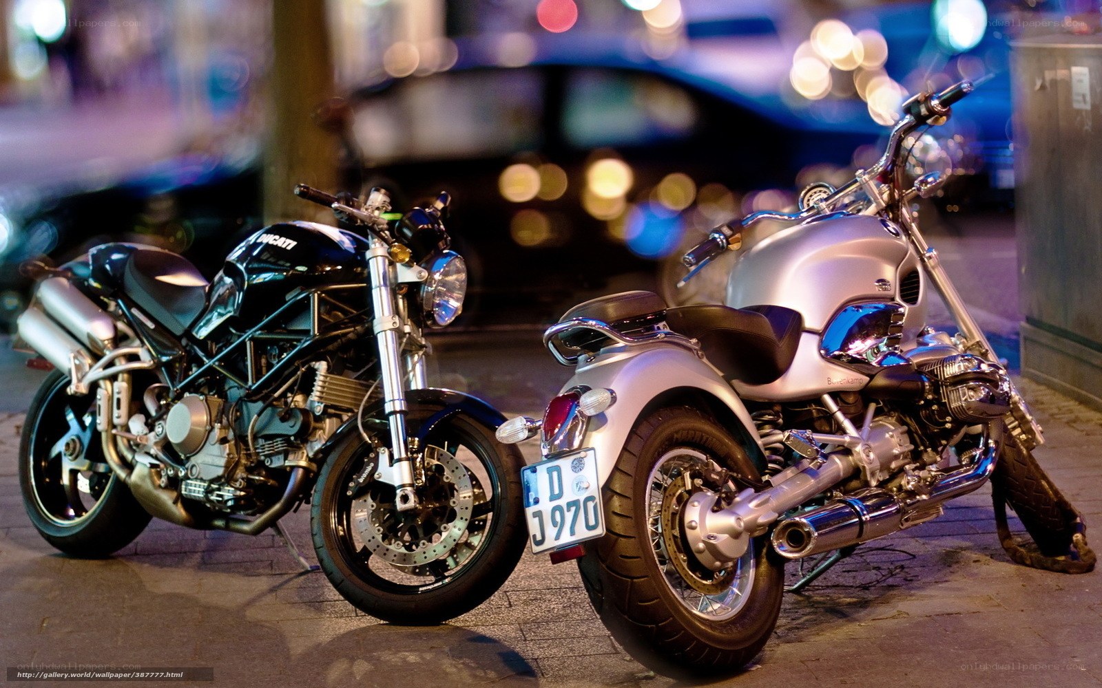 Two motorcycles parked at night