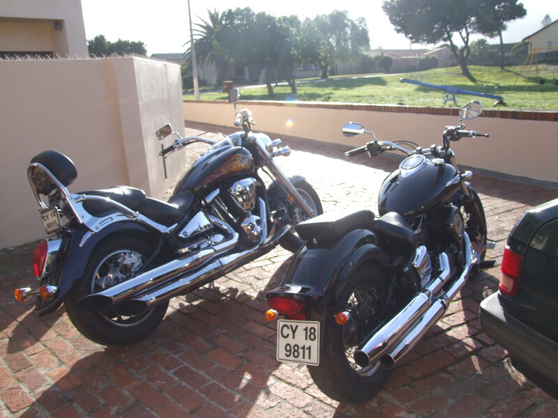 Two motorcycles parked outside