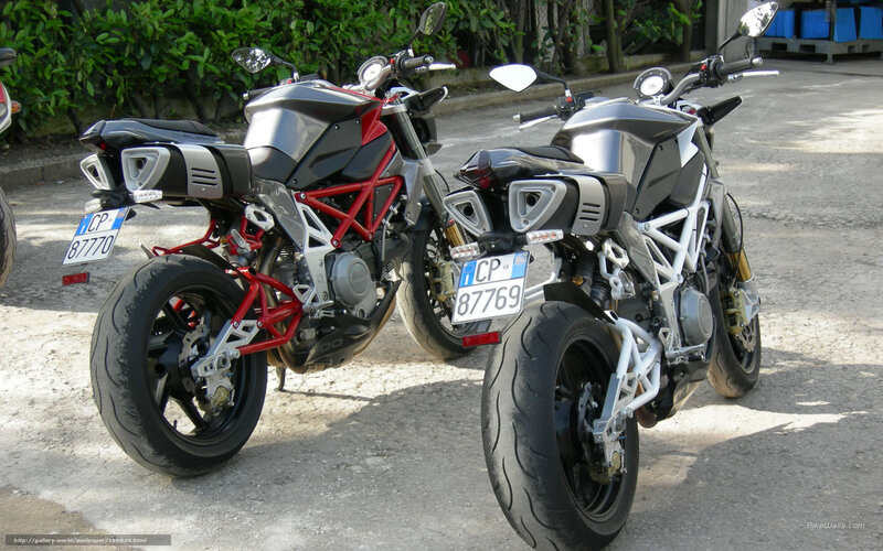 Two motorcycles parked side by side