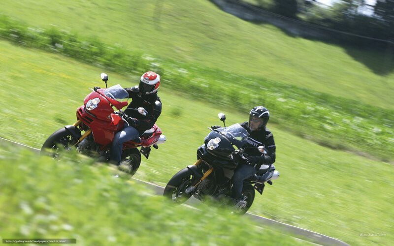 Two motorcyclists on a country road