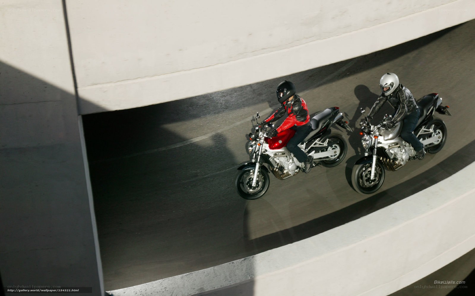 Two motorcyclists on a ramp