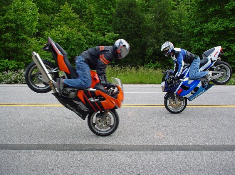 Two Motorcyclists on Road — Orange