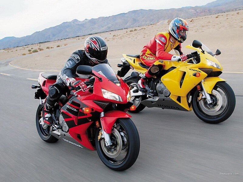 Two motorcyclists racing on a track