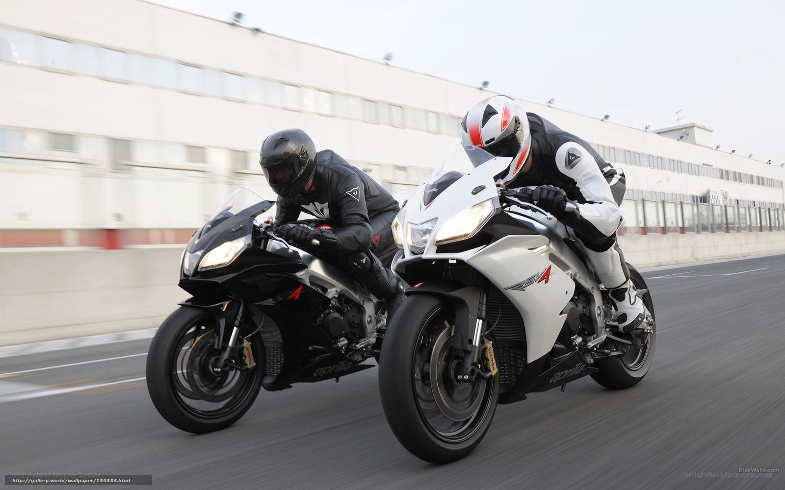 Two motorcyclists racing on a track