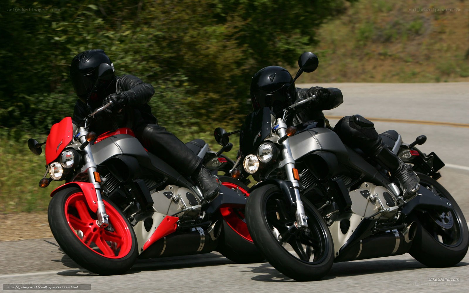 Two motorcyclists riding on a road