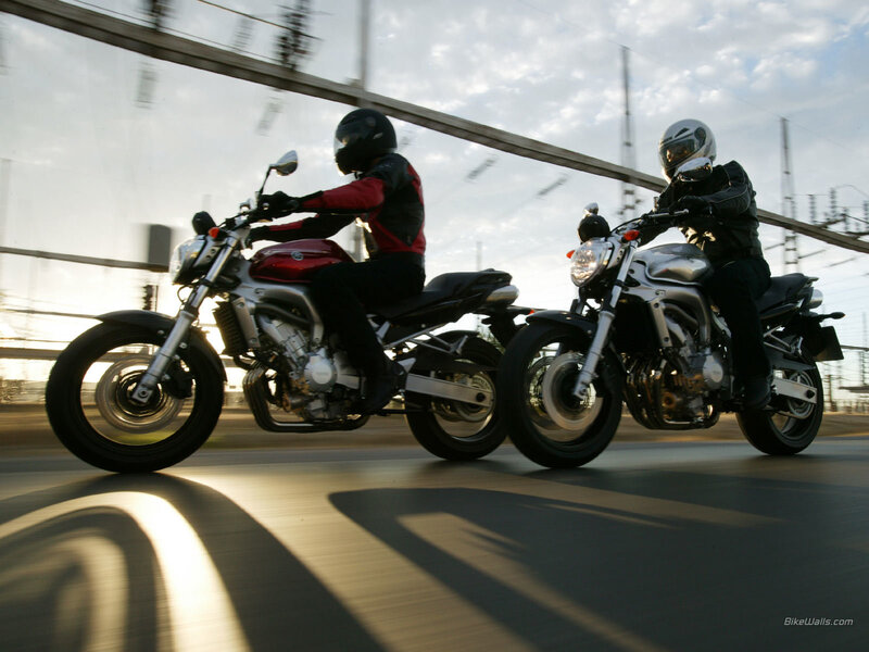 Two motorcyclists riding side by side