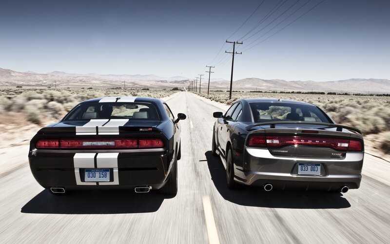Two Muscle Cars — Black, Dramatic, Afternoon
