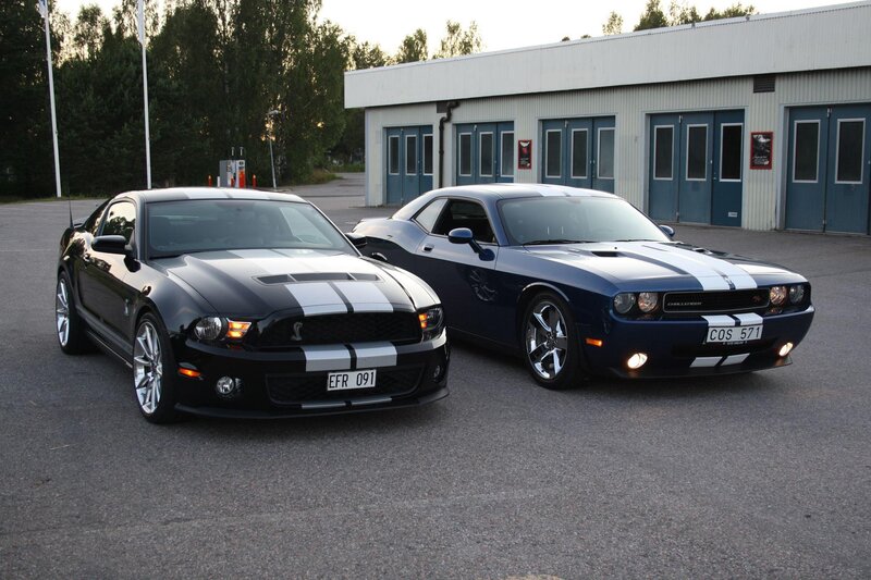 Two muscle cars parked