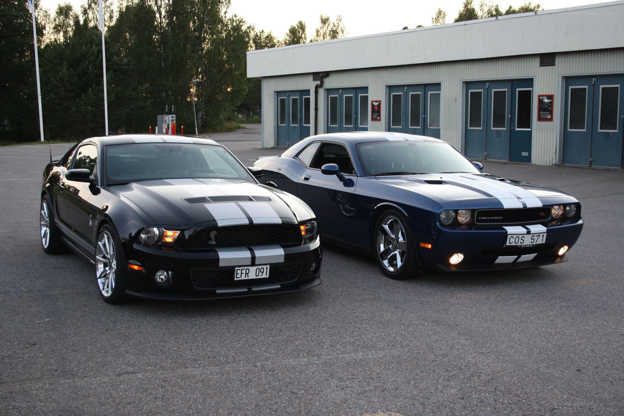 Two muscle cars parked