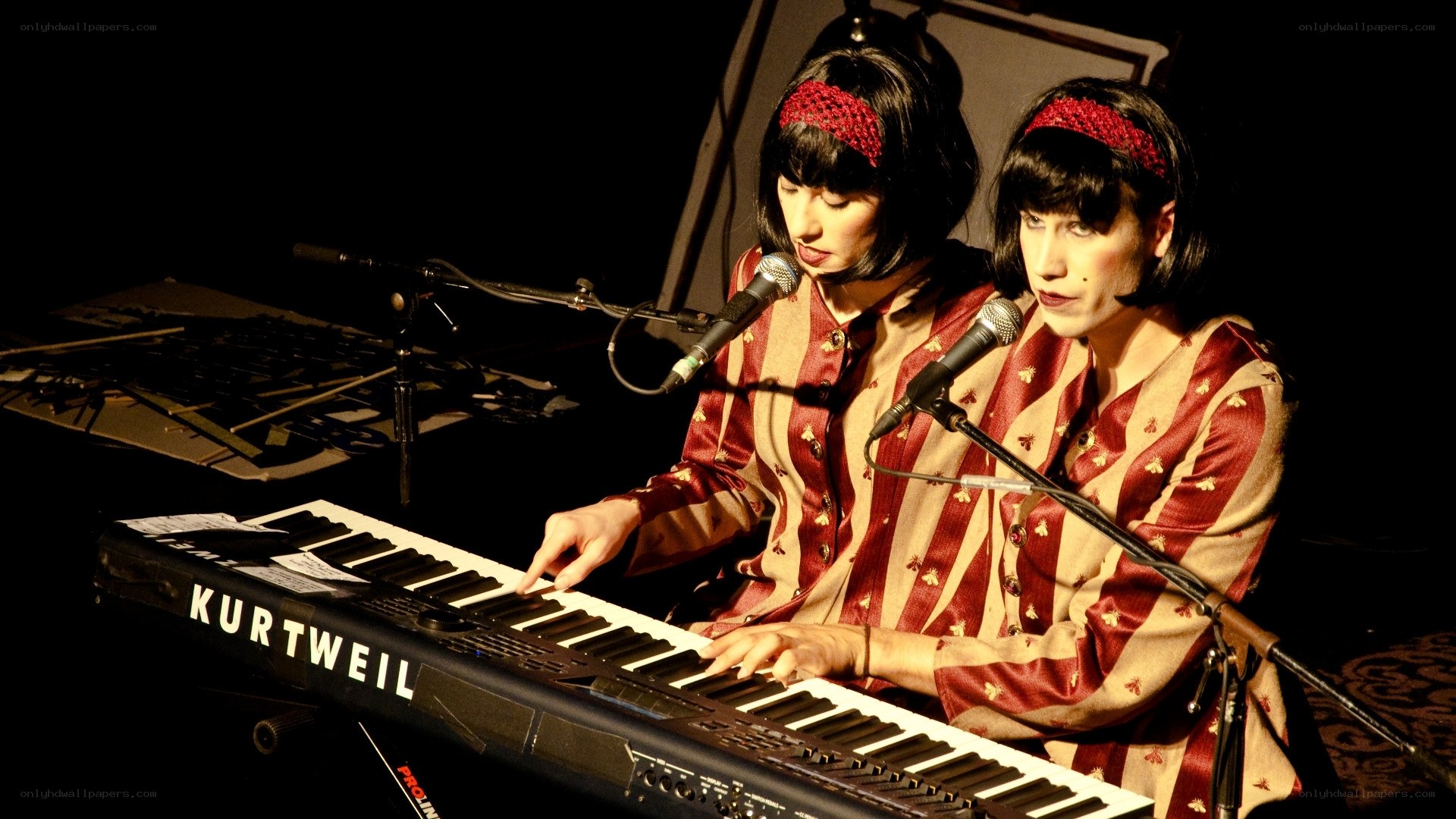 Two musicians playing keyboard